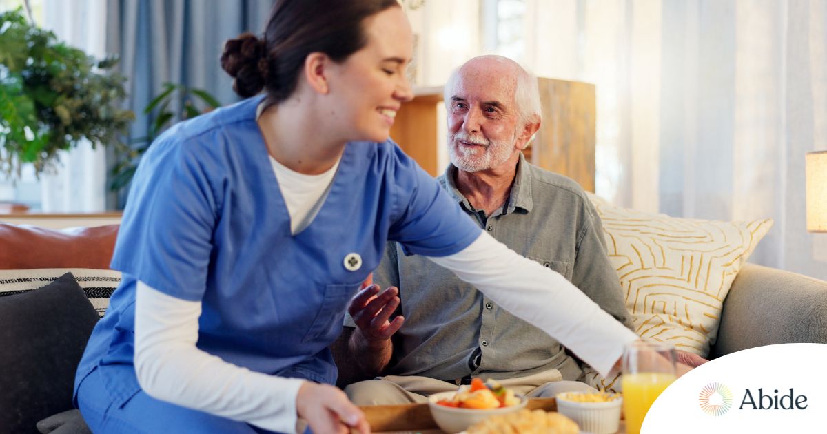 Caregiver providing senior care at home to manage parkinson’s and related symptoms.