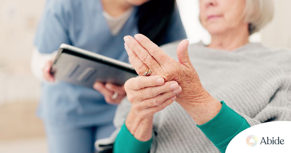 A caregiver provides in home care services to a senior with arthritis