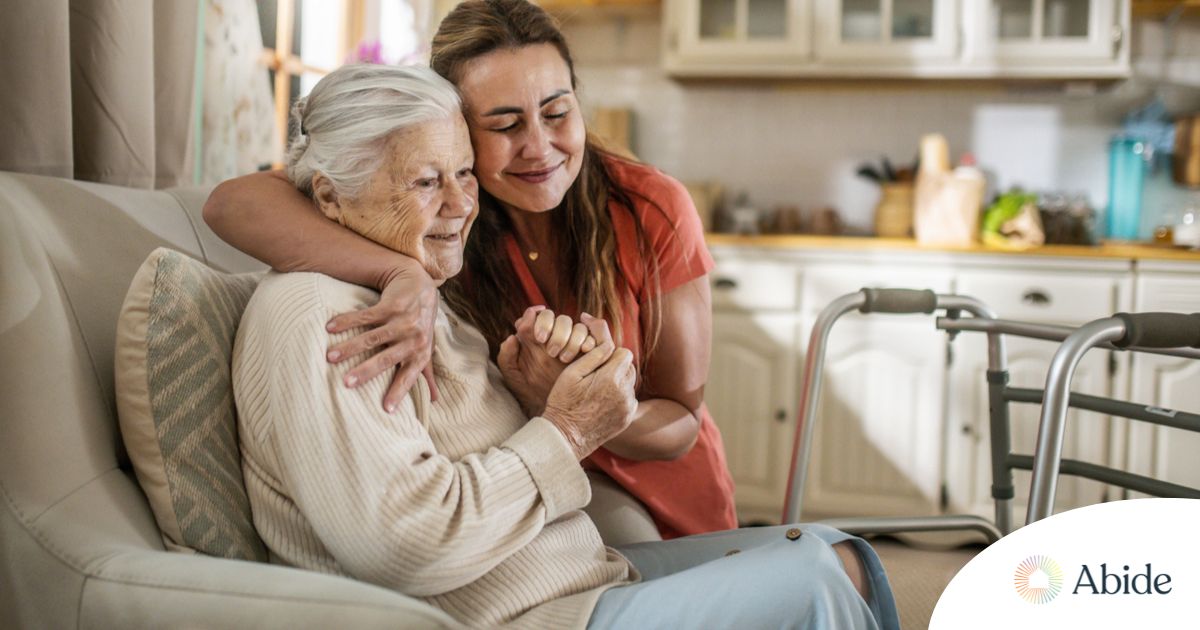 Caregiver supporting an elderly woman in the transition to senior home care