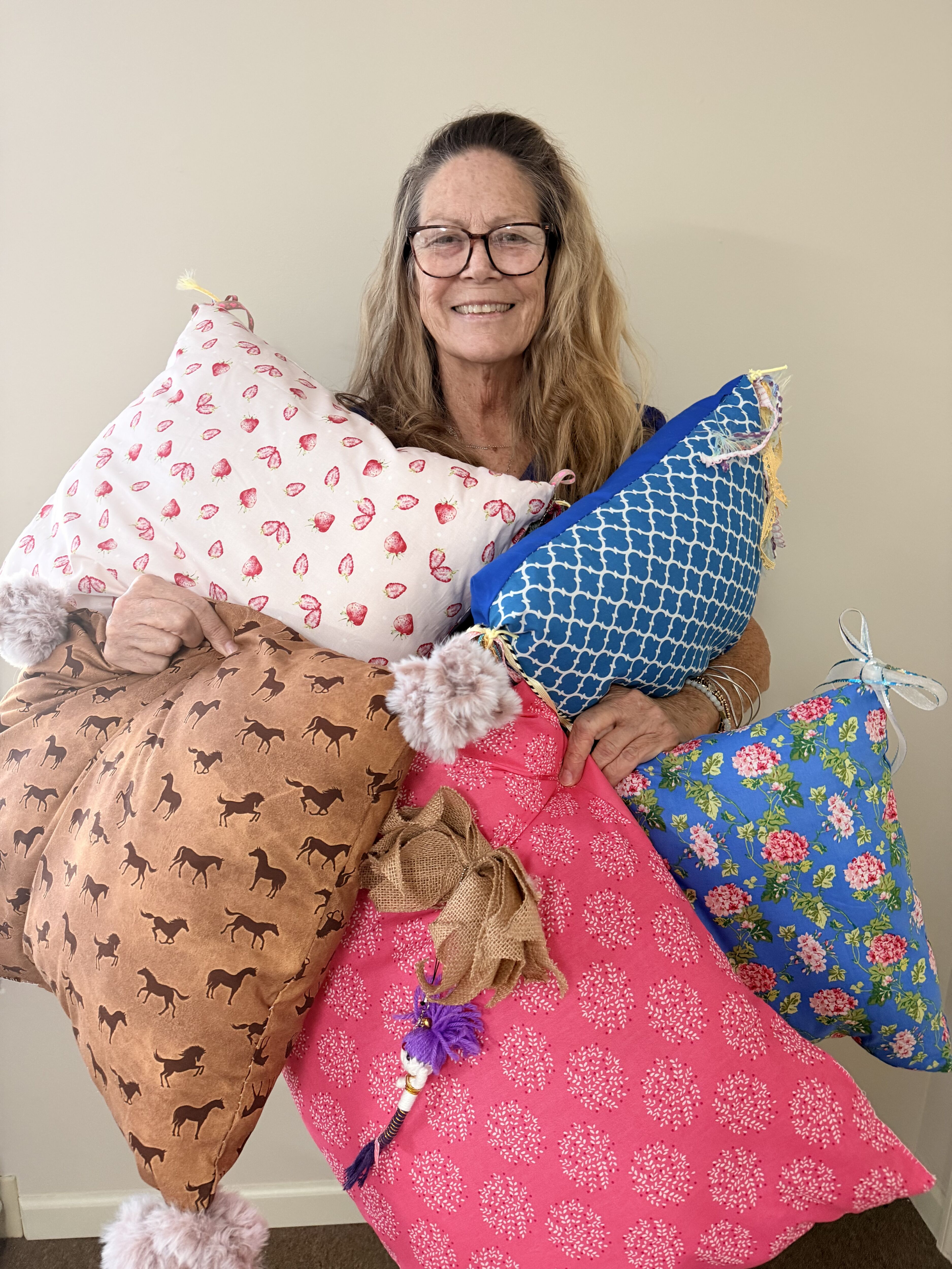 Tifton Caregiver Betsy Stobbs Gives Back Abide Home Care Tifton caregiver Betsy Stobbs with handmade pillows donated for senior community activities