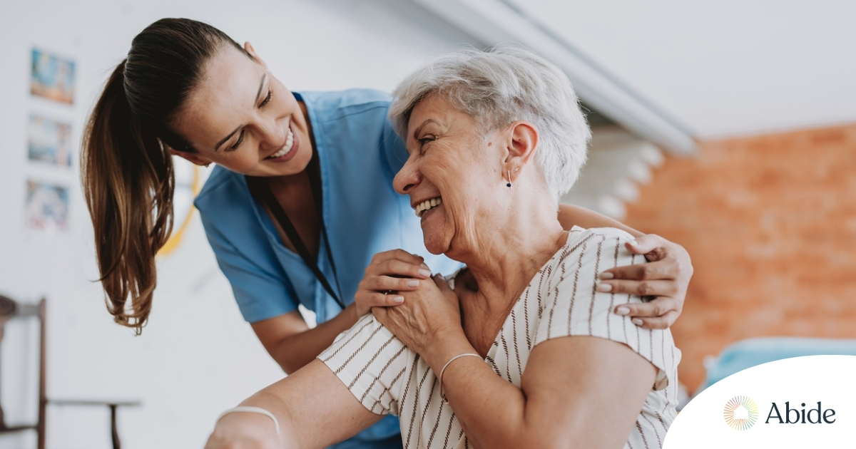 A female caregiver helping an older woman with stroke recovery at home A female caregiver helping an older woman with stroke recovery at home.